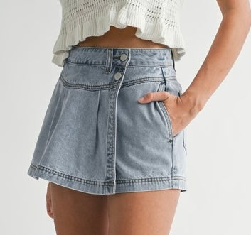 Denim pleated skort with wrap design, snap button closure, pleated detail, versatile day-to-night skirt-short hybrid.