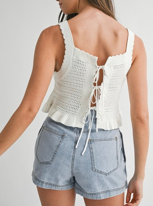 Denim pleated skort with wrap design, snap button closure, pleated detail, versatile day-to-night skirt-short hybrid.