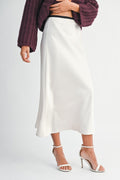Woman wearing a satin slip midi skirt with a contrast waistband, styled for an elegant and modern day-to-night look.